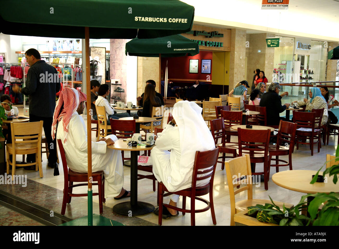 Customers drink coffee, Abu Dhabi, UAE Stock Photo Alamy