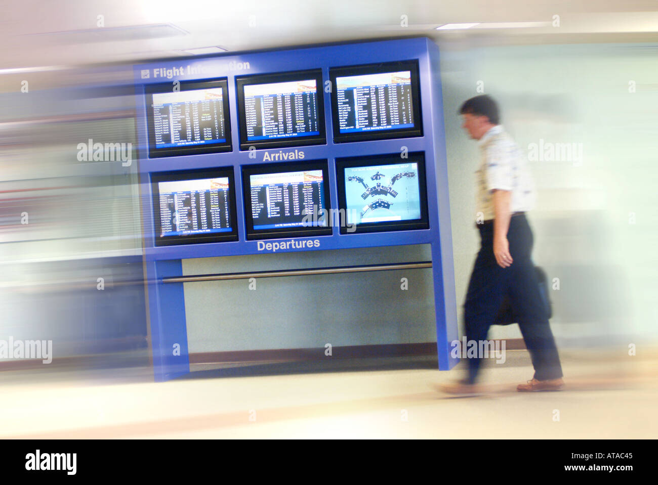 Computer monitors with colored screens at airport Stock Photo