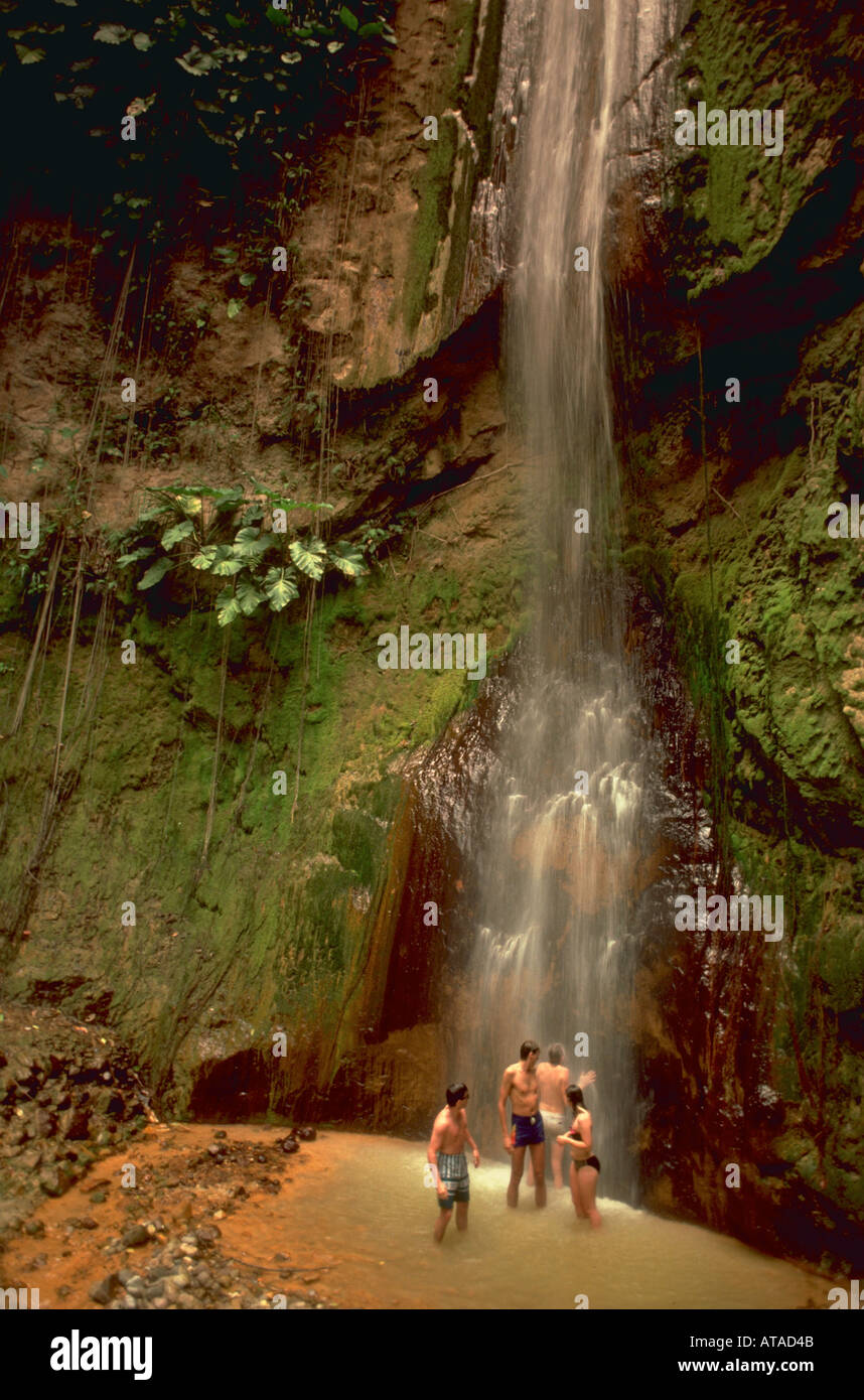 Four people standing under waterfall on Montserrat Leeward Island West