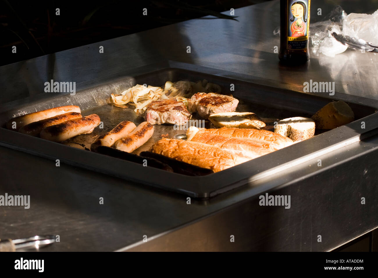 Sausages and chops sizzle on a barbecue Stock Photo