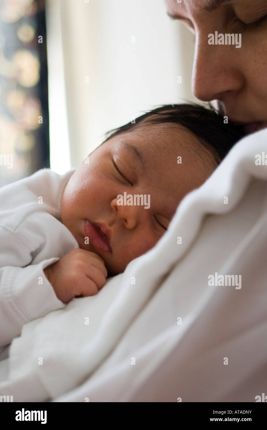 Baby sleeping on mothers shoulder hires stock photography and images