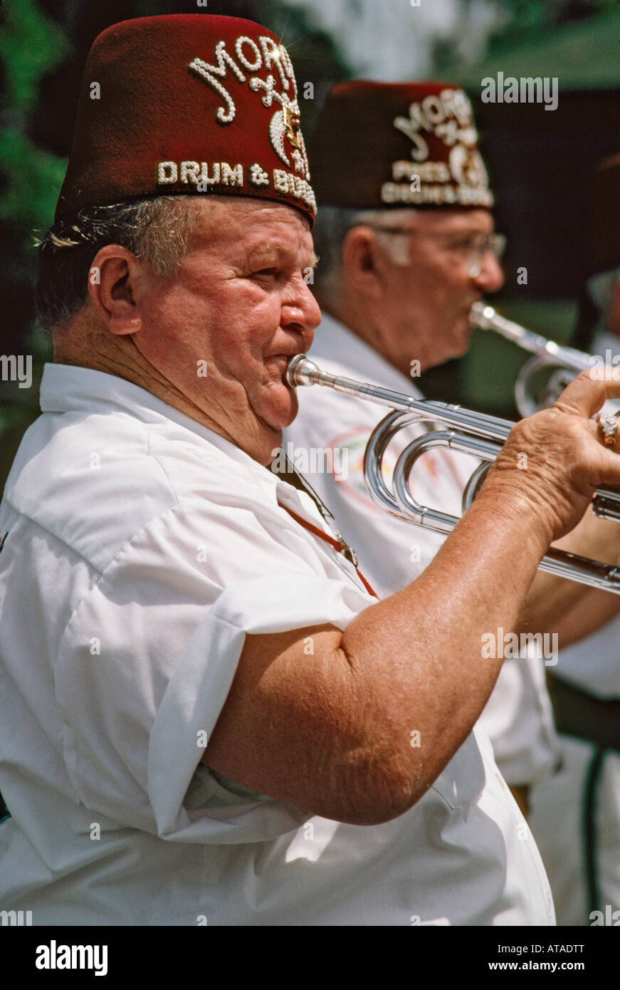 Shriners playing trumpets in a parade during the Catfish Festival in