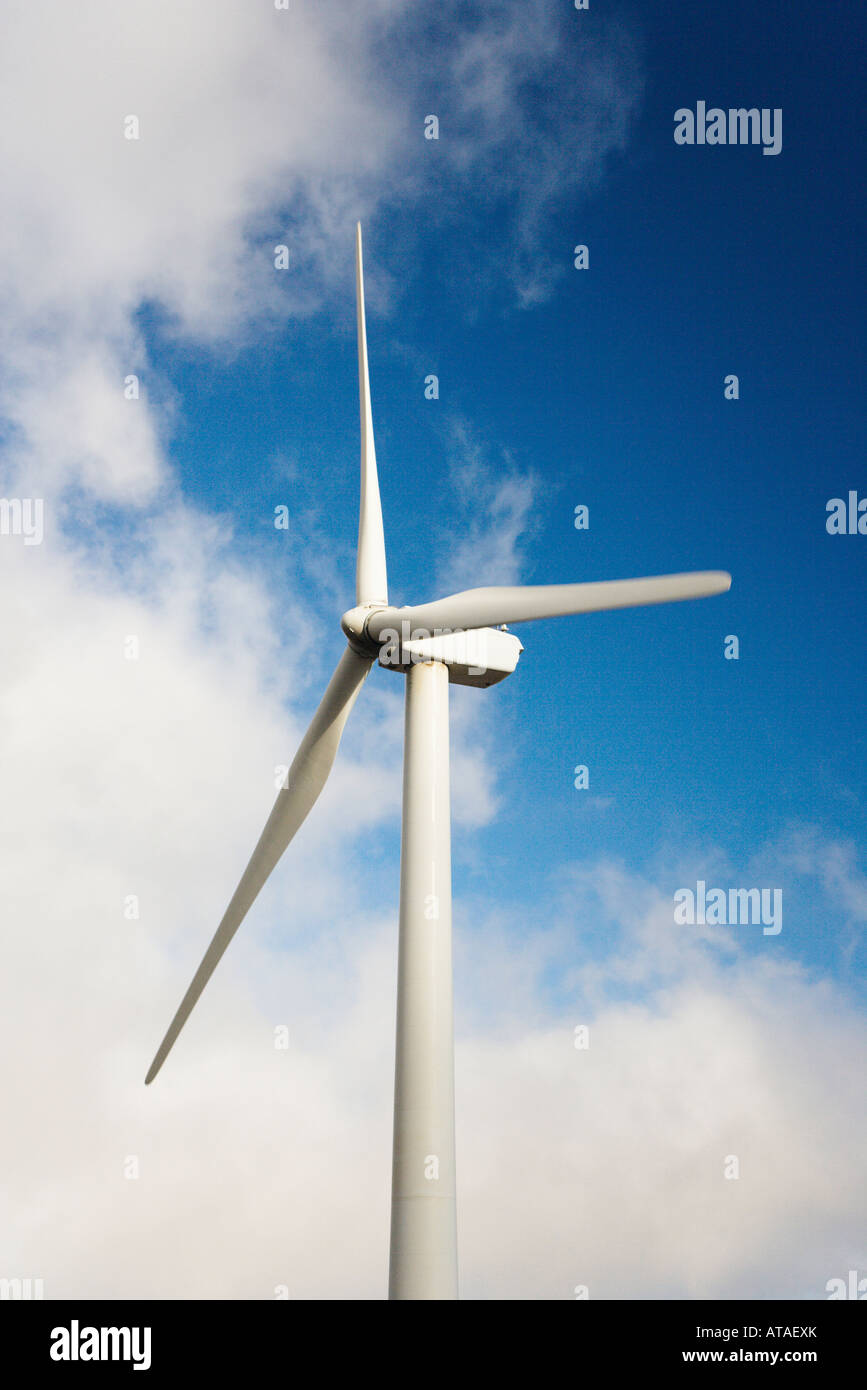 Wind turbine against blue sky and clouds Stock Photo - Alamy