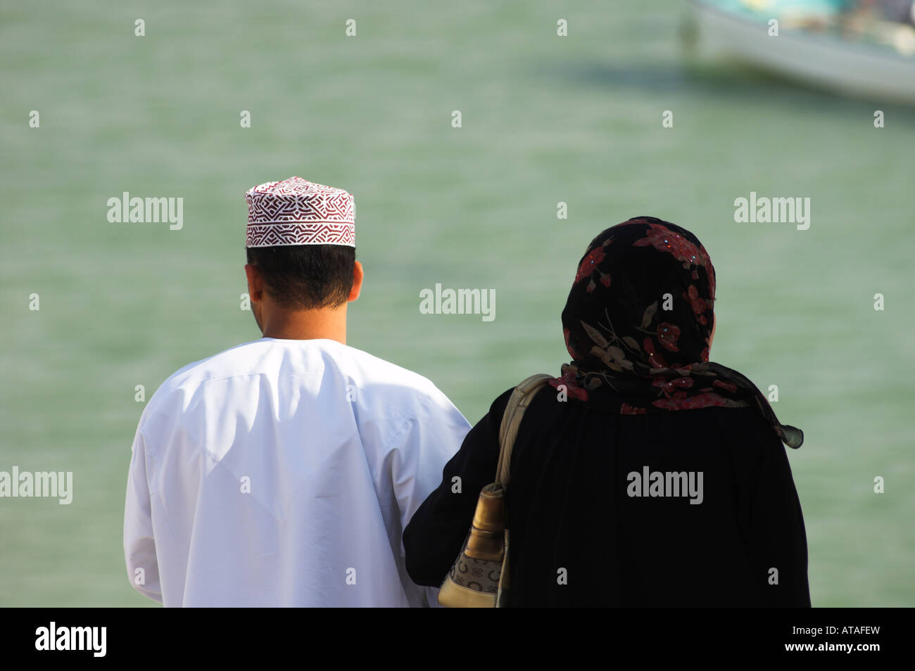 Omani couple looking out at sea Stock Photo