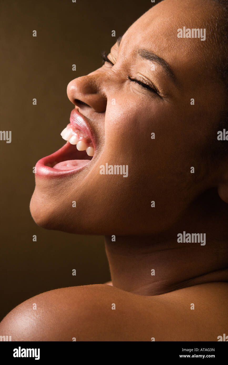 Portrait of smiling African American young adult female singing Stock ...
