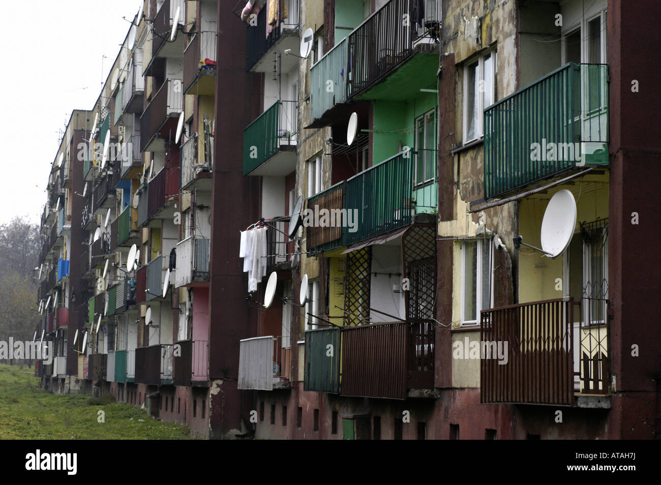 Balconies with dish antennas on a block of flats, Poland Stock Photo