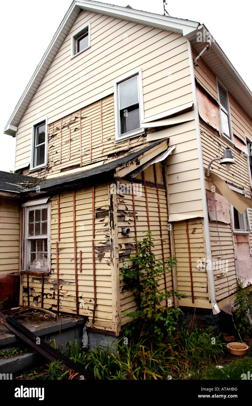 Run-down house in ghetto with siding stolen Stock Photo - Alamy