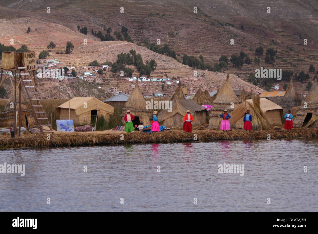 Villagers at Uros floating reed village Lake Titicaca Peru Stock Photo