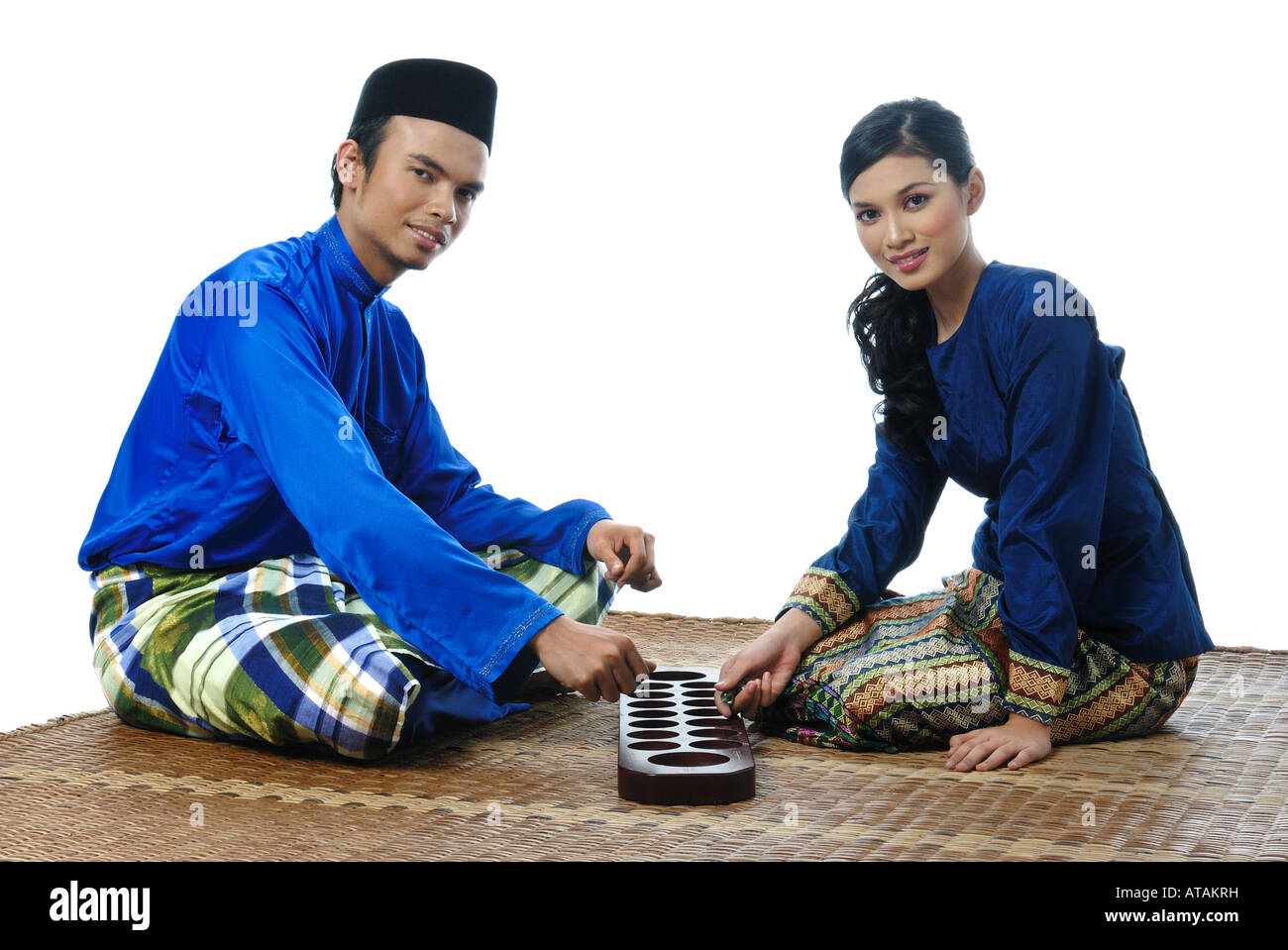 Malaysian Muslim Couple Play Congkak Stock Photo