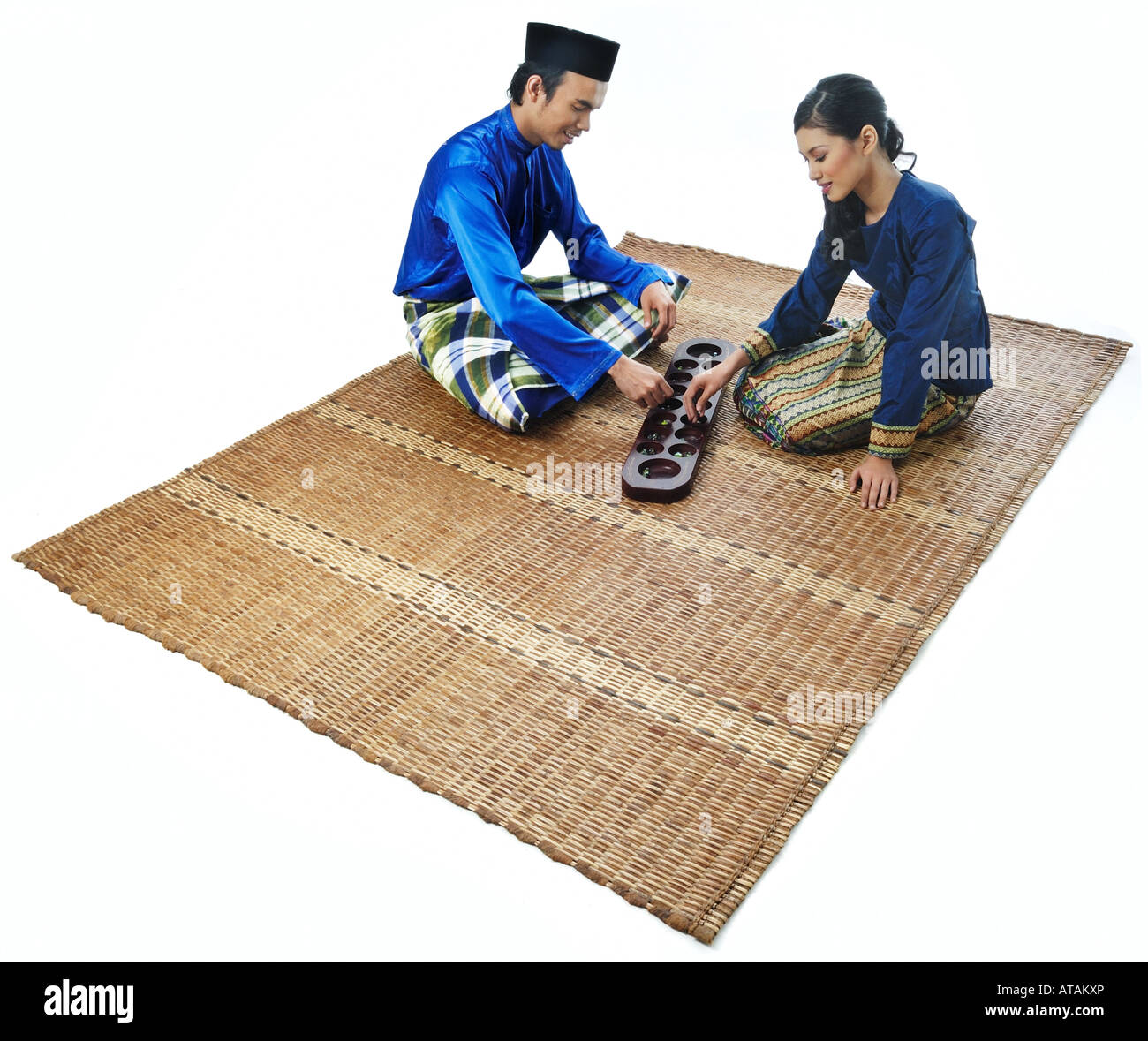Malaysian Muslim Couple Play Congkak Stock Photo