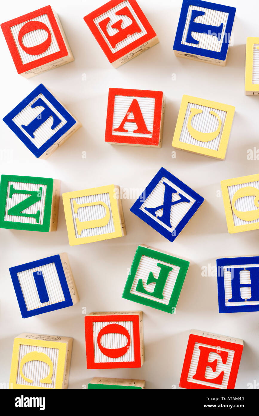 Alphabet building block toys scattered on white background Stock Photo