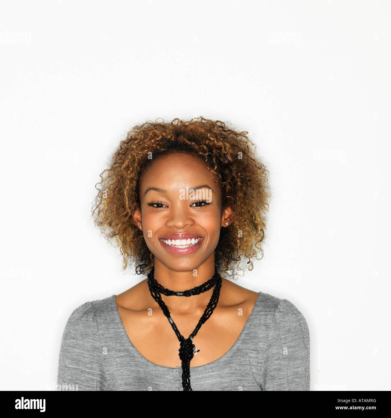 Portrait of pretty young woman smiling on white background Stock Photo ...