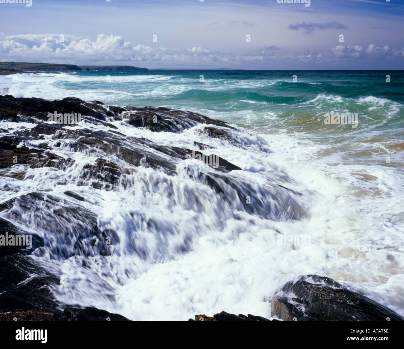 Rough seas splashing against black volcanic rocks, Booby Bay, North Cornwall, England, UK Stock Photo