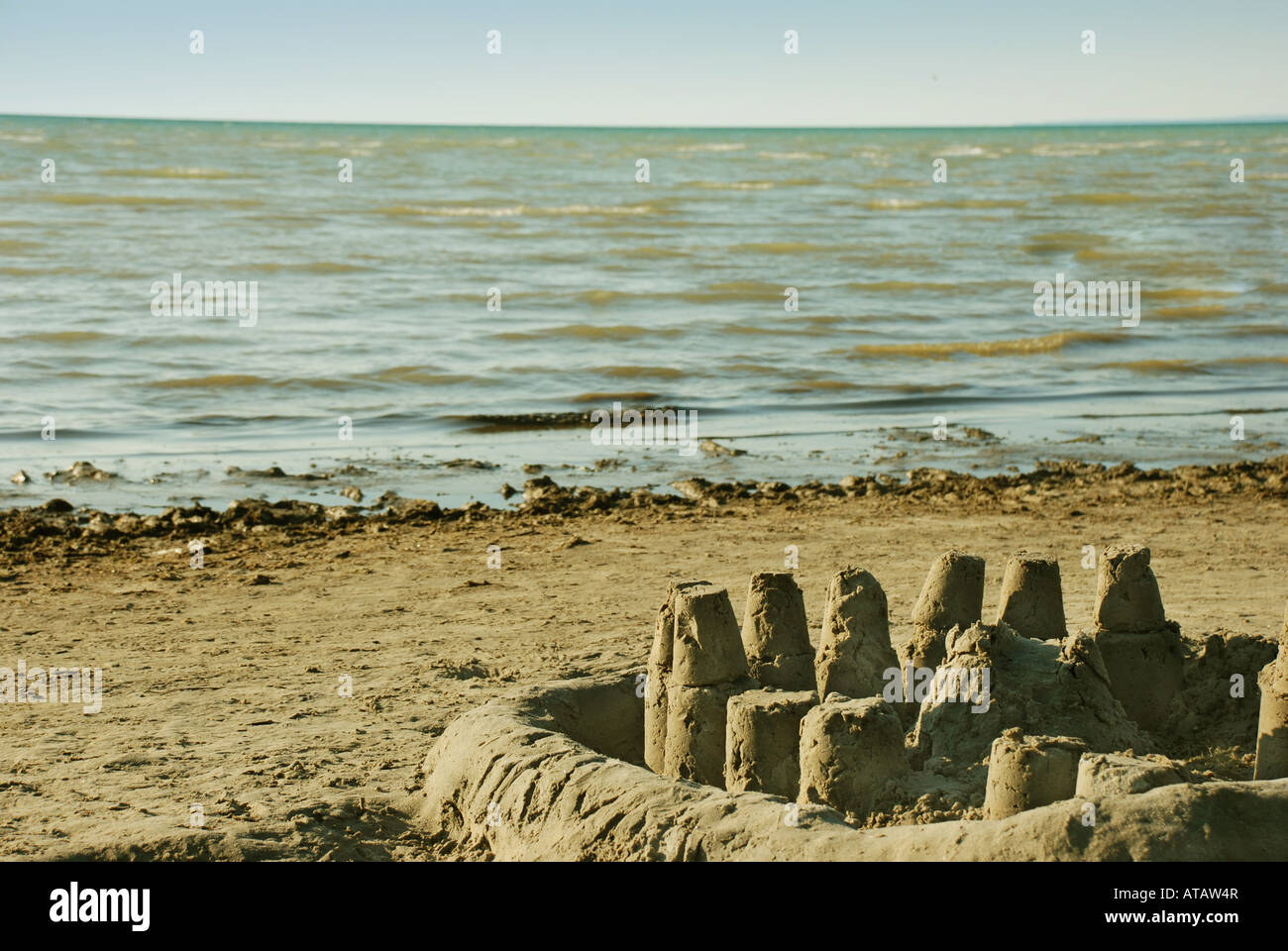 Sand castle at the beach with the ocean in the background Stock Photo