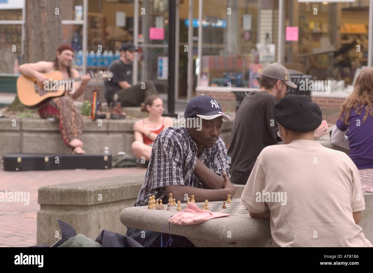 A chess match on The Commons pedestrian marketplace Ithaca New York Stock Photo