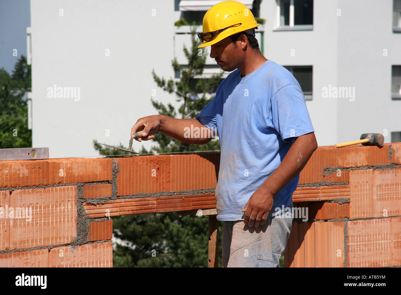 Workers building up a brick wall Stock Photo Alamy