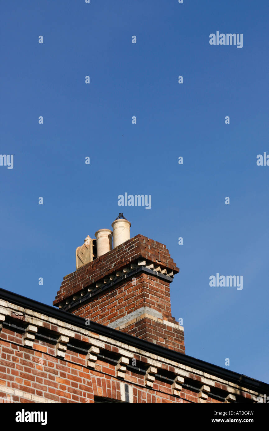 Chimney stack on top of house roof Stock Photo