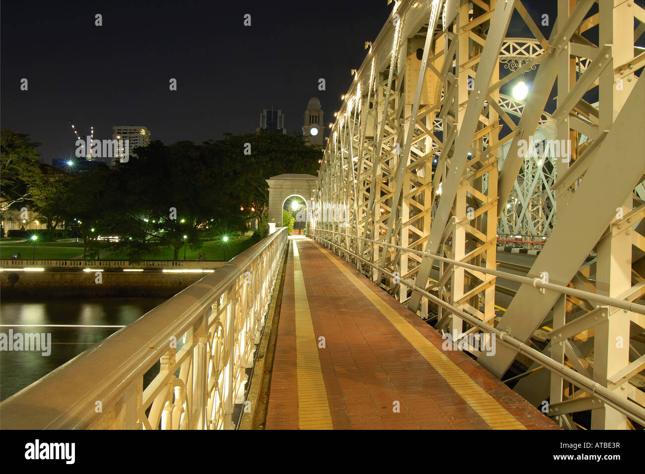 brightly lit Cavenagh Bridge next to the Fullerton Hotel in the inner city of Sinagpore, Singapore, Singapore Stock Photo