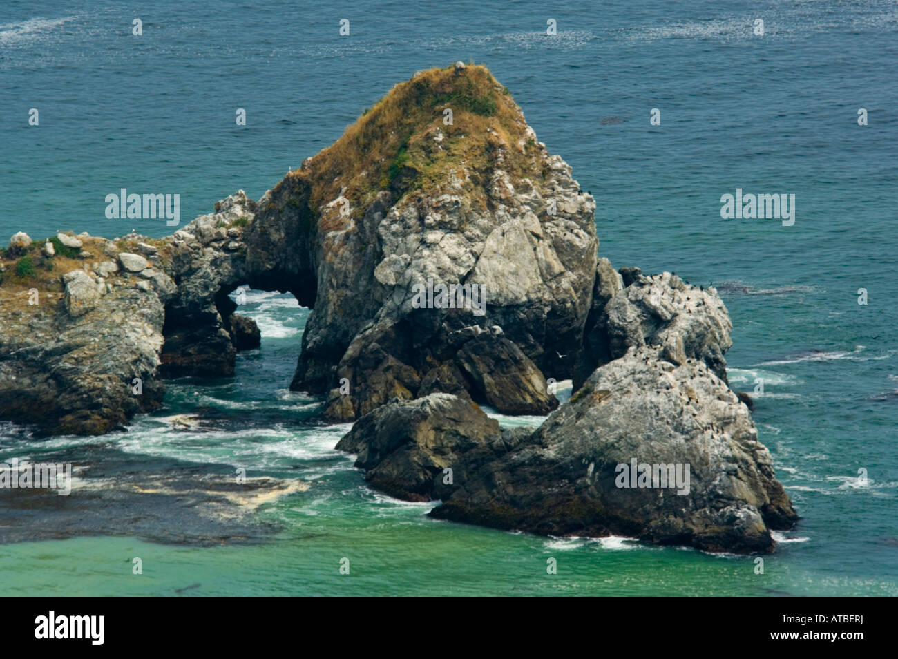 Offshore rock sea stacks in green ocean water along the Big Sur Coast ...