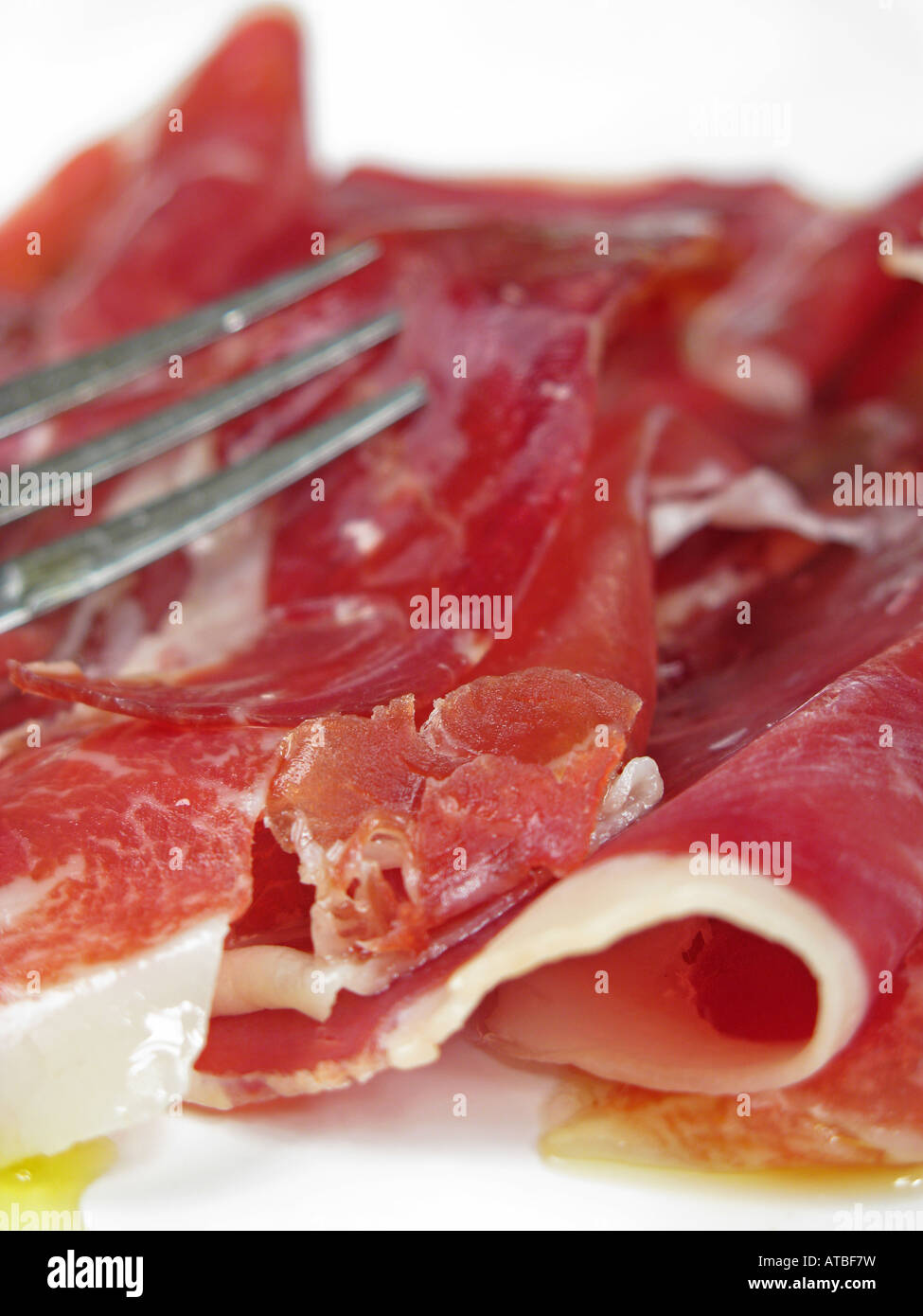 Thinly-sliced Spanish Jamon Iberico de Bellota. Stock Photo