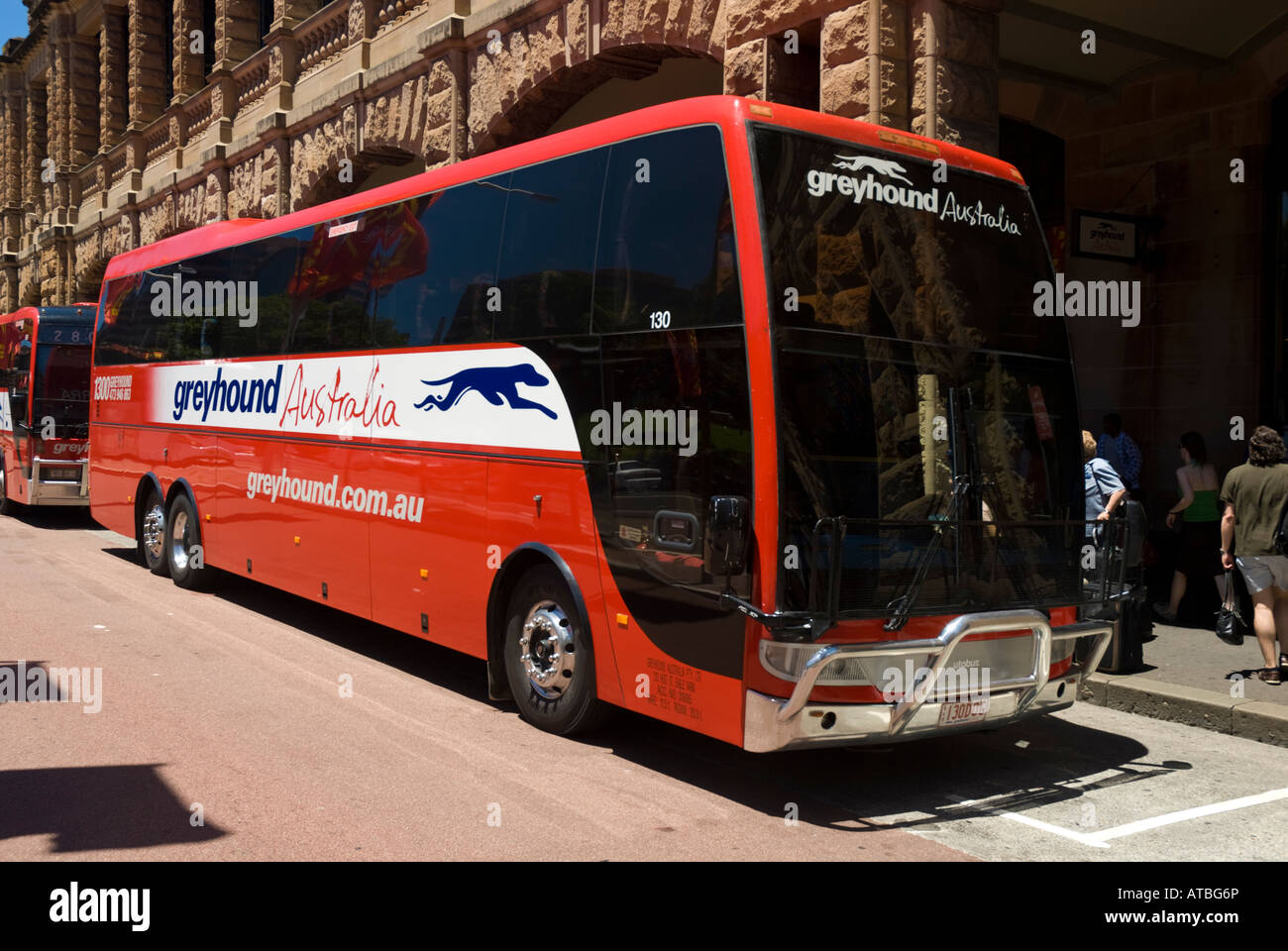 Modern red greyhound bus or coach at the terminus of its journey. Long distance coach or bus; public transport Australia; Australian transportation. Stock Photo