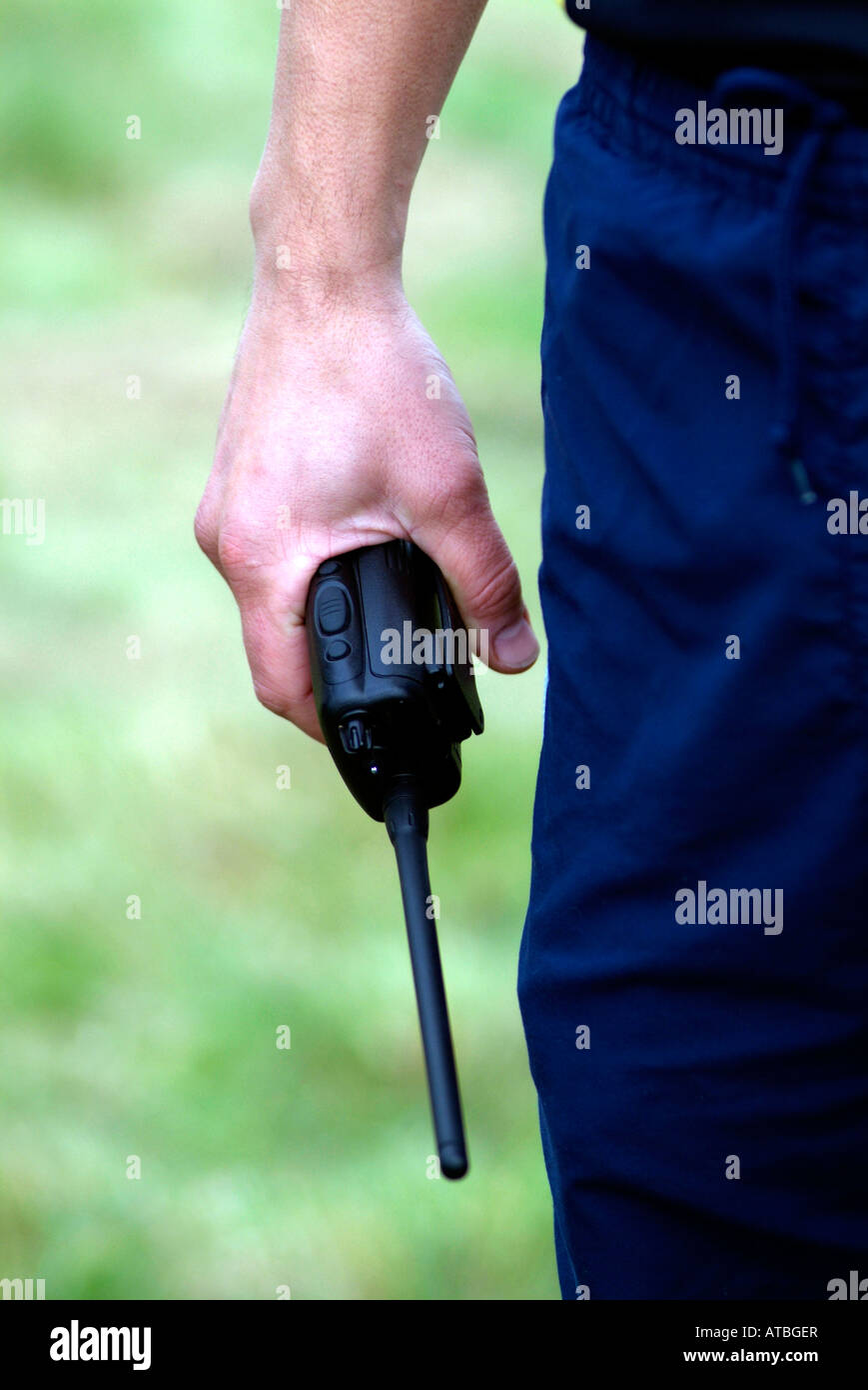 mans hand holding a walkie talkie two way radio Stock Photo Alamy
