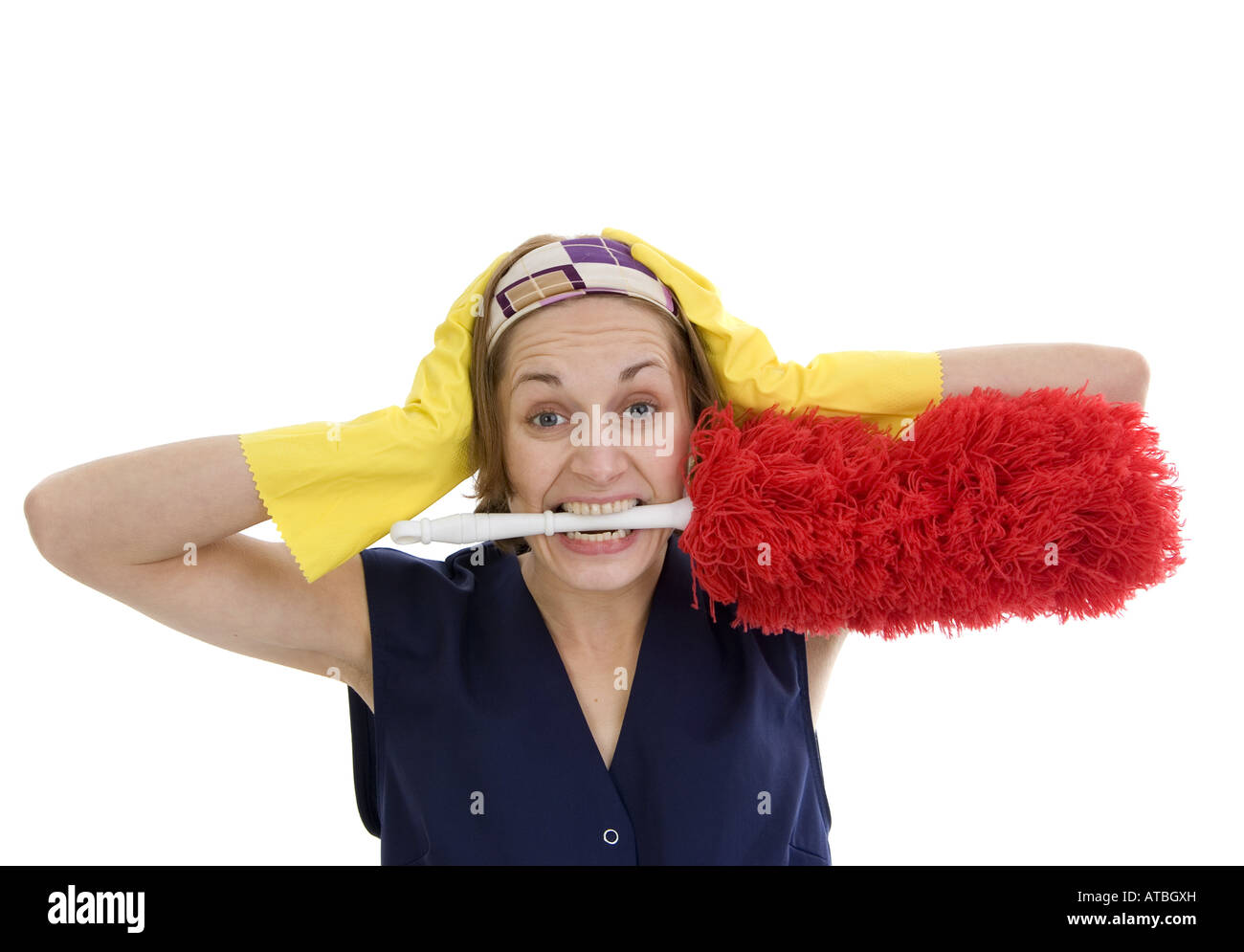 charwoman in panic, with feather duster in her mouth Stock Photo