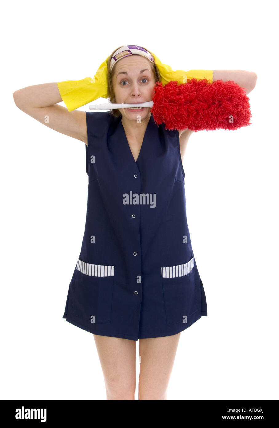 charwoman in panic, with feather duster in her mouth Stock Photo