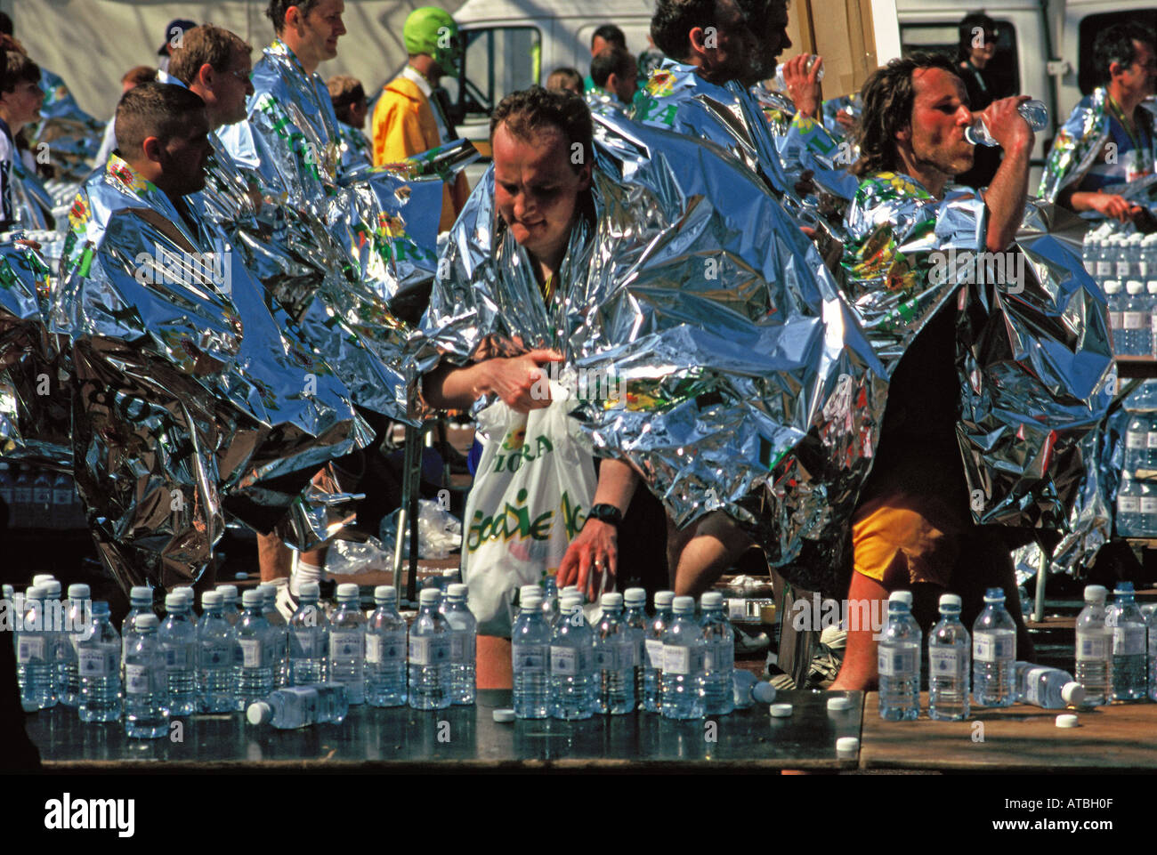 London marathon runners at the finish line collecting water and Stock