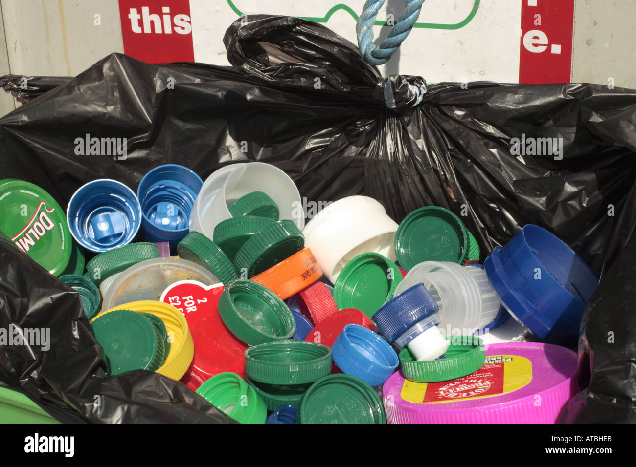 plastic jar & bottle caps in recycling bin Stock Photo