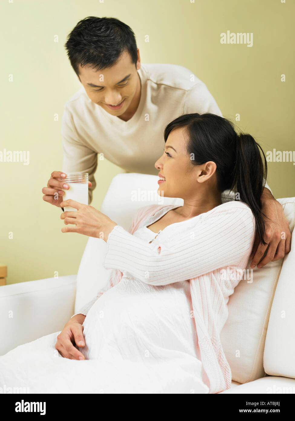 husband and wife holding a glass of milk Stock Photo - Alamy