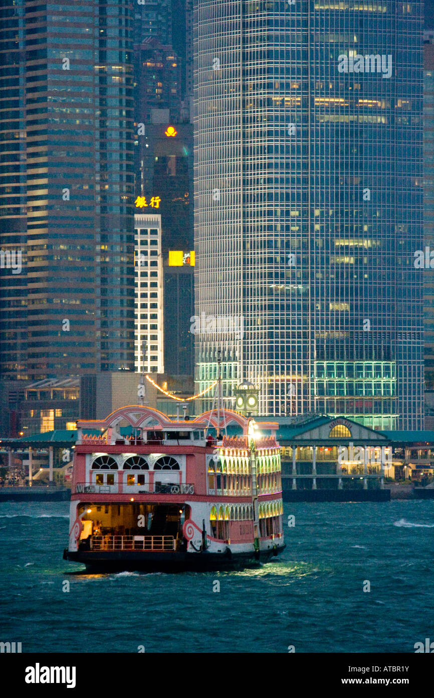 Tourist Cruise Boat in Victoria Harbour near IFC Building in Central Hong Kong Stock Photo
