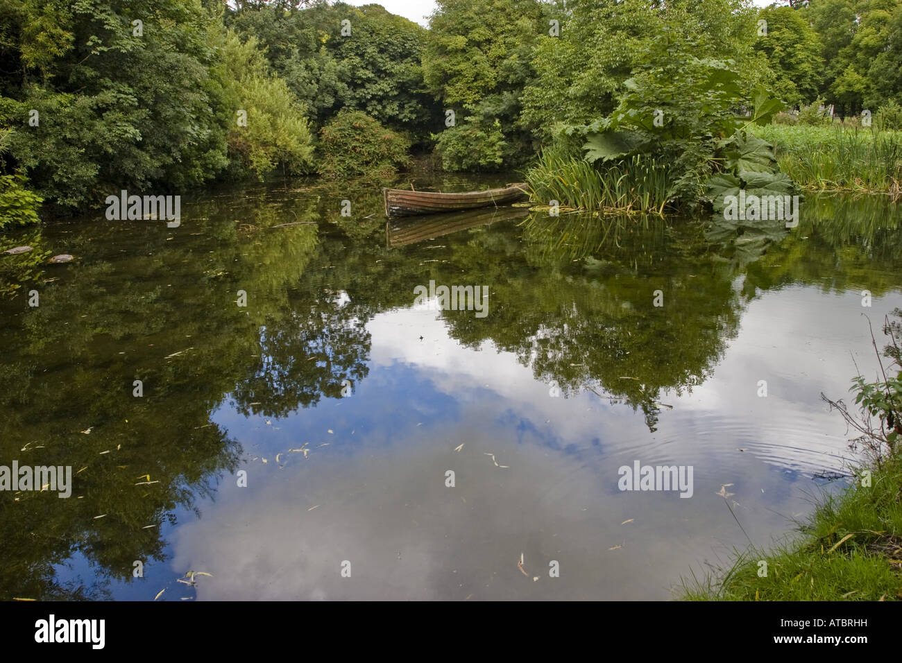 pond with rawing boat, Ireland, Clarens, Bunratty Castle and Folk Park, Bunratty Stock Photo