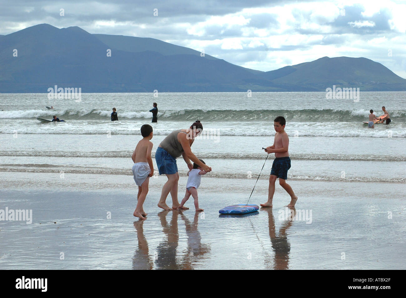 Family play time on the huge beach of INCH where cars can be parked while swimming or surfing Co Kerry Ireland Stock Photo