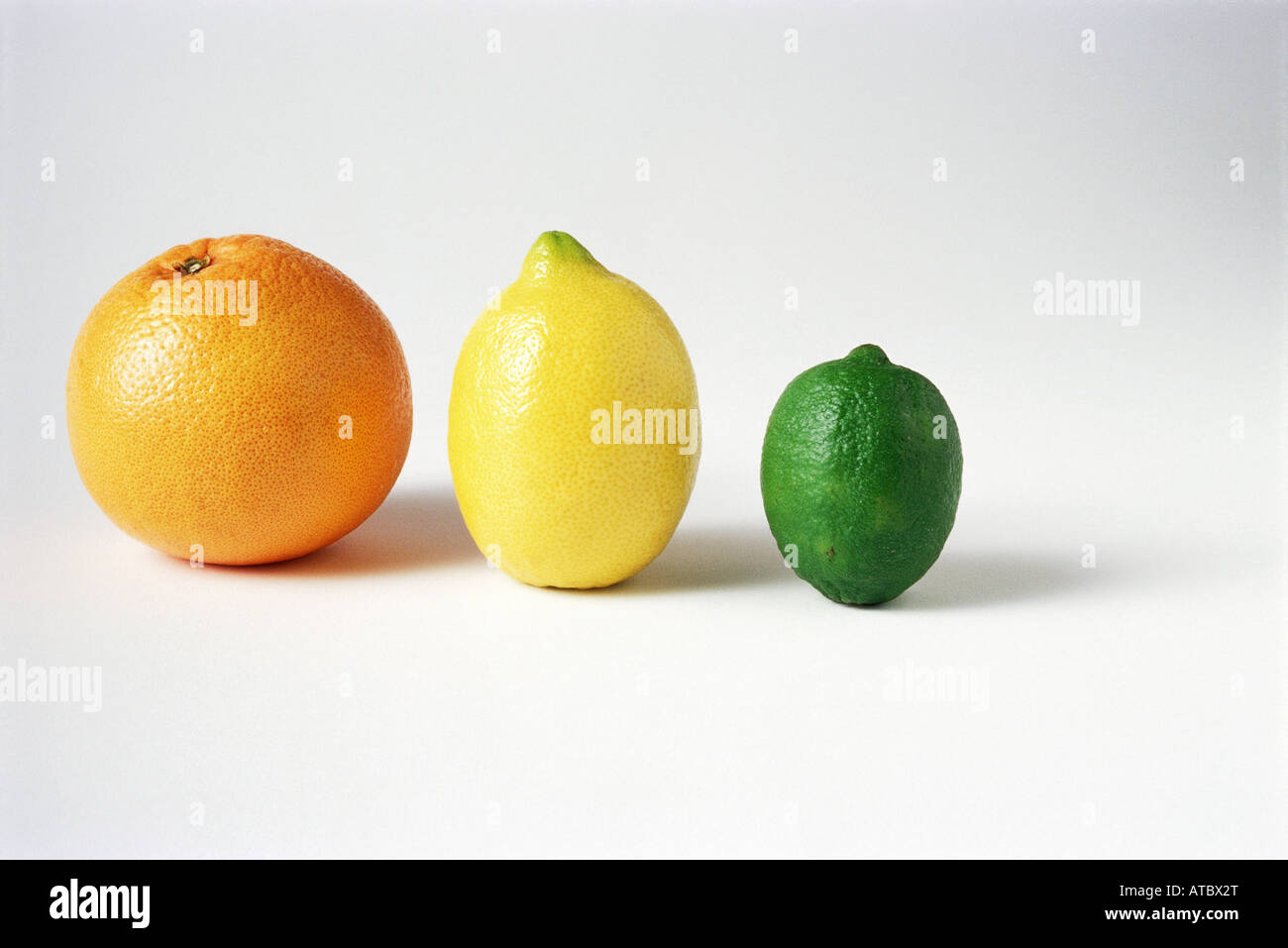 Orange, lemon, and lime in a row, close-up Stock Photo