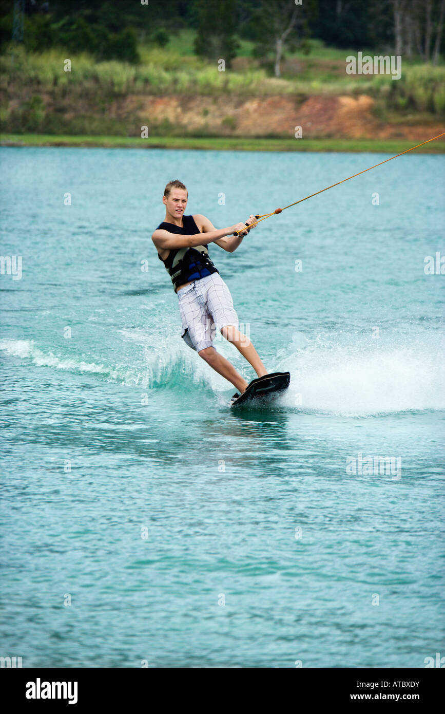 Caucasian young adult male wakeboarding on lake Stock Photo Alamy