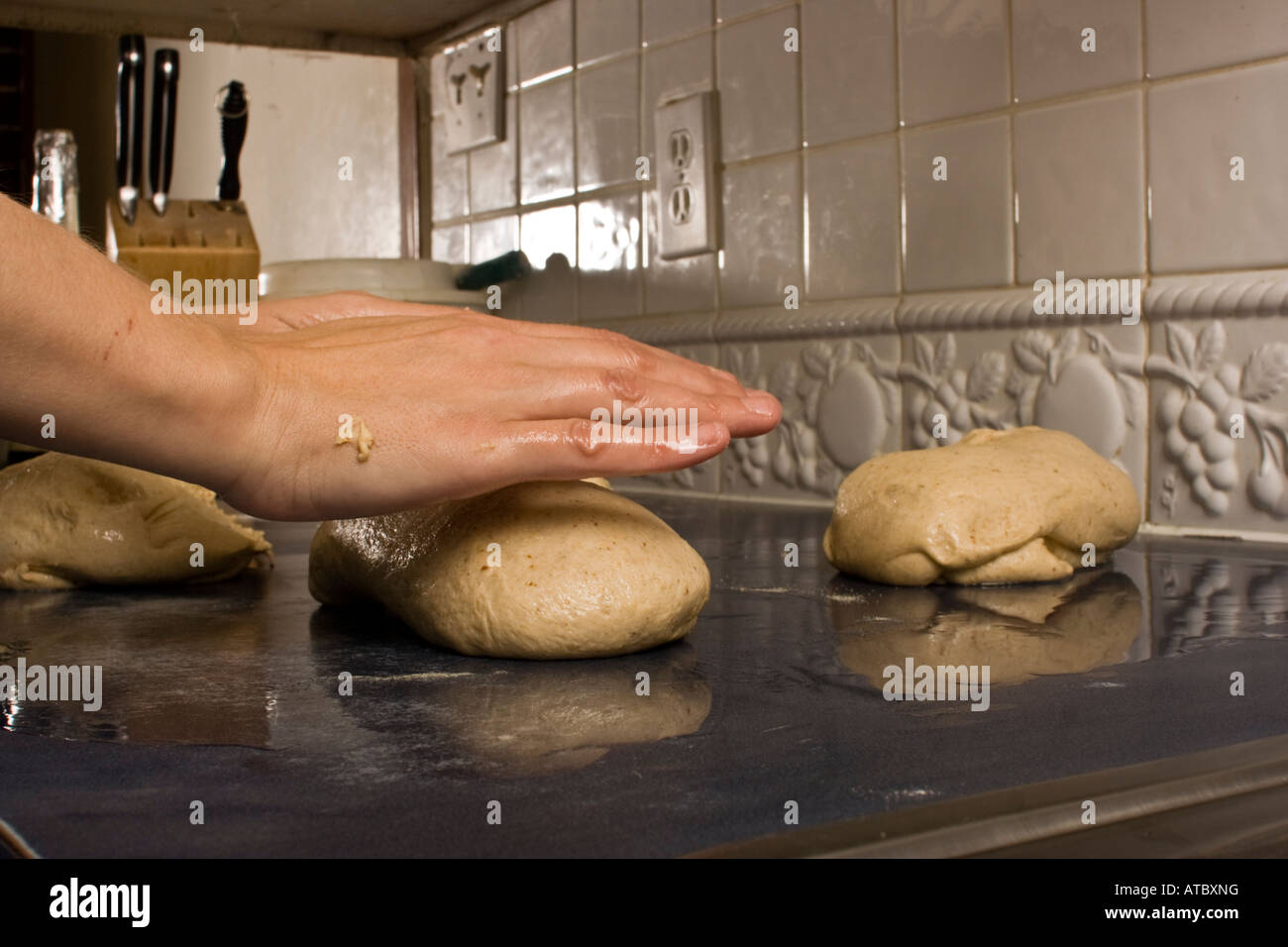 Makeing homemade bread showing hands folding dough Stock Photo Alamy