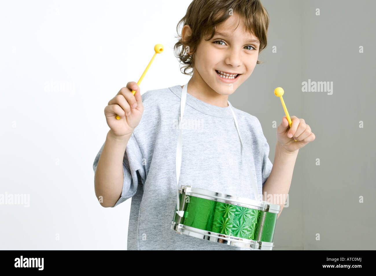 Little boy playing drum, smiling at camera Stock Photo Alamy