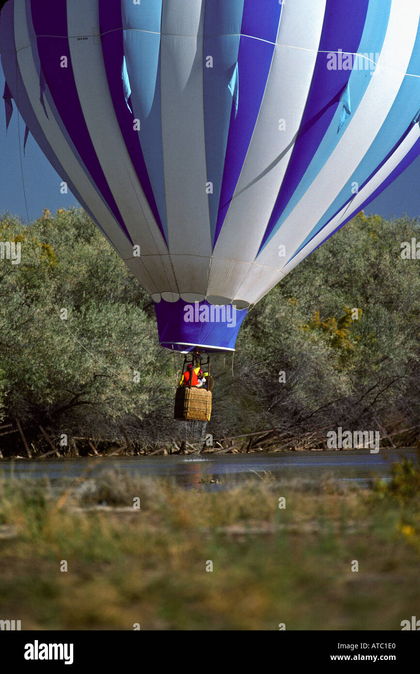 Hot air balloon dips its basket into the Rio Grande River in splash and