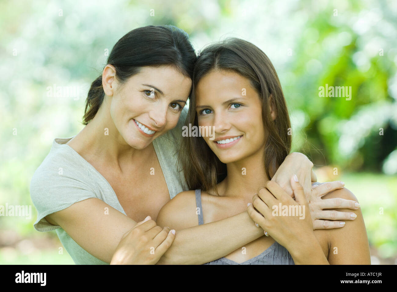 Mother and daughter smiling at camera together, portrait Stock Photo
