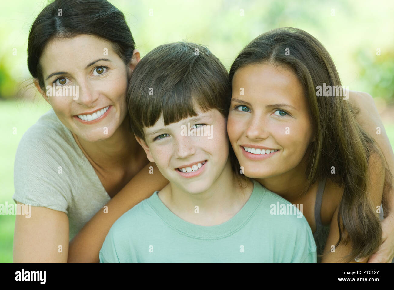 Mother with teenage daughter and son, all smiling at camera, portrait Stock Photo
