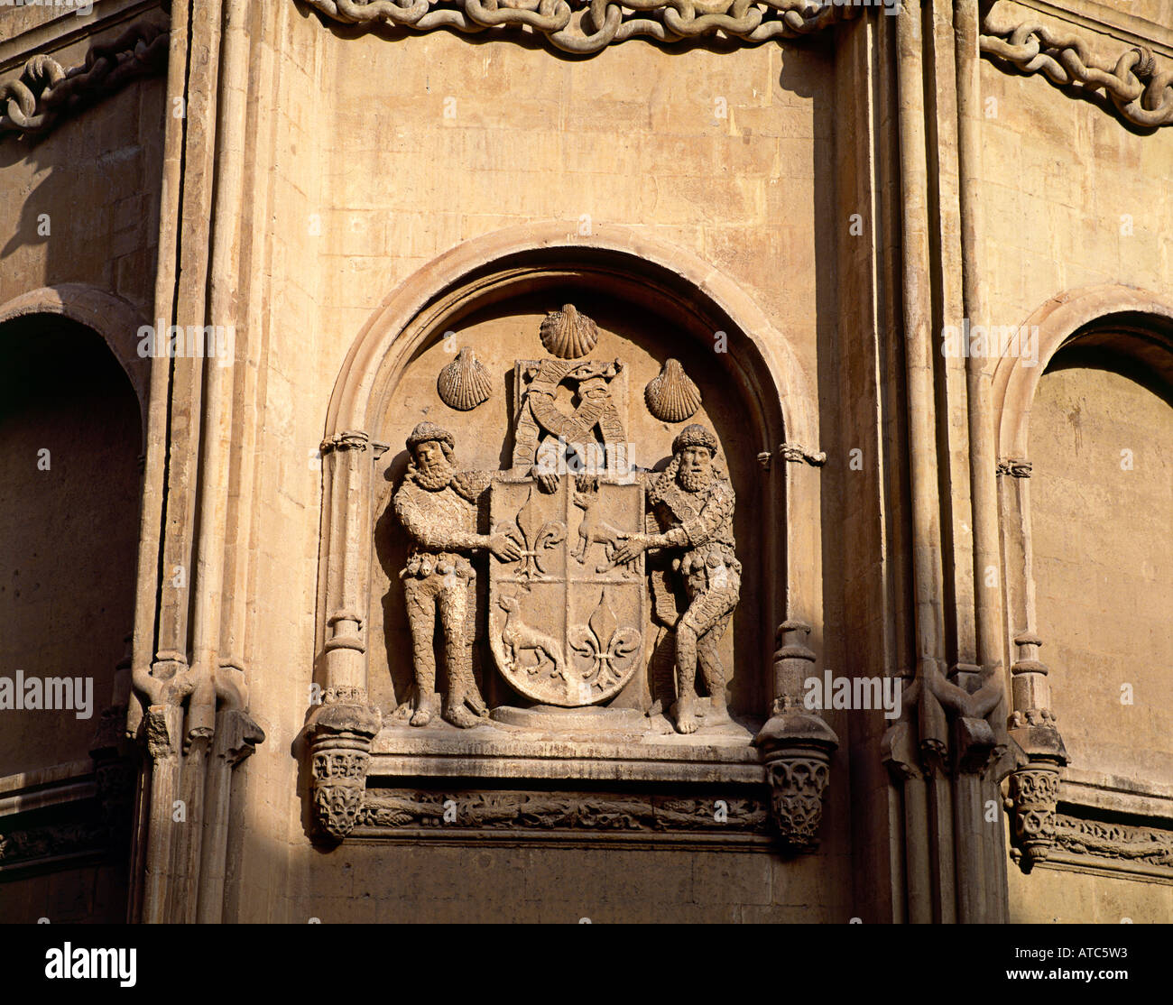 Carved Stone Statues Flank A Crest Which Is Set In A Large Arched
