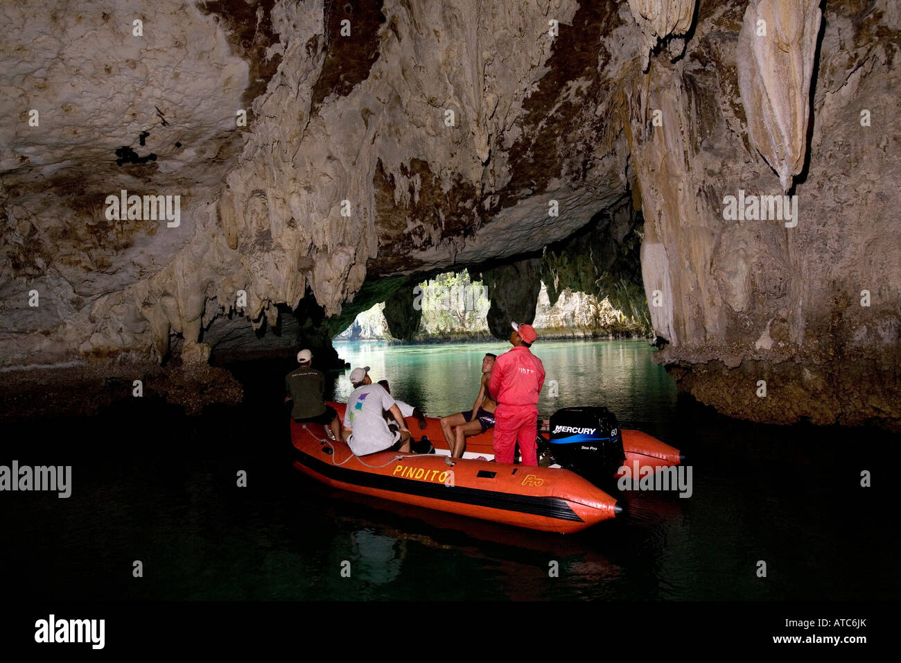 Tourists exploring a cave with zodiac Raja Ampat Irian Jaya West Papua Pacific Ocean Indonesia Stock Photo