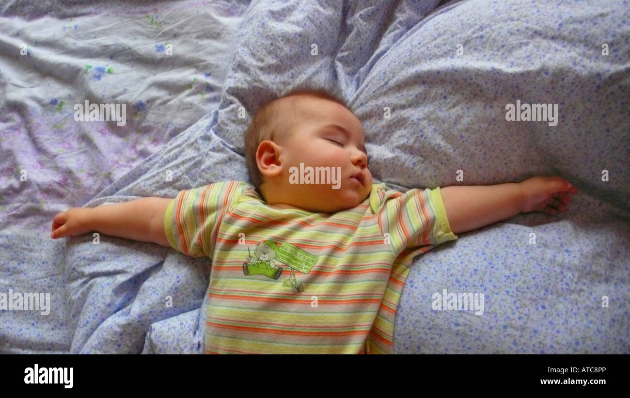 baby sleeeping with outstretched arms Stock Photo Alamy