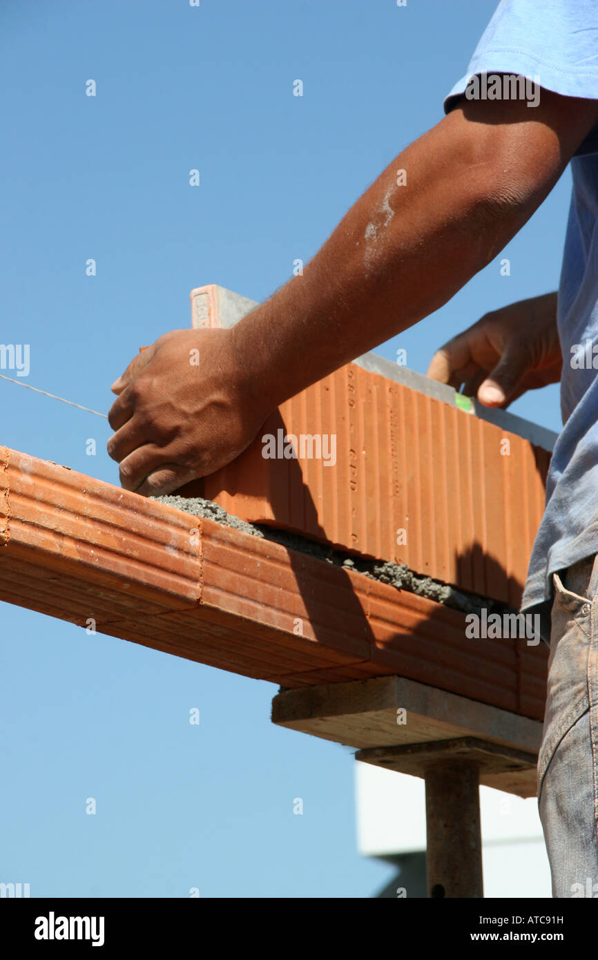 Workers building up a brick wall Stock Photo Alamy