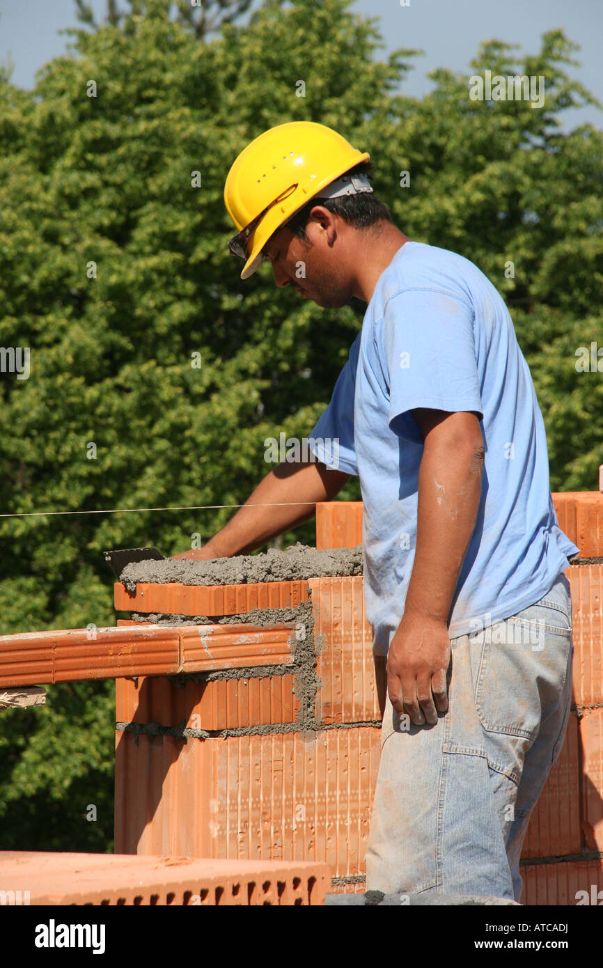 Workers building up a brick wall Stock Photo - Alamy