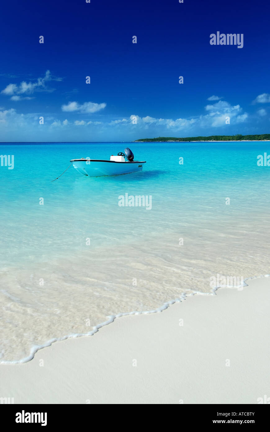A blue sky, white sand beach tropical paradise. Stock Photo