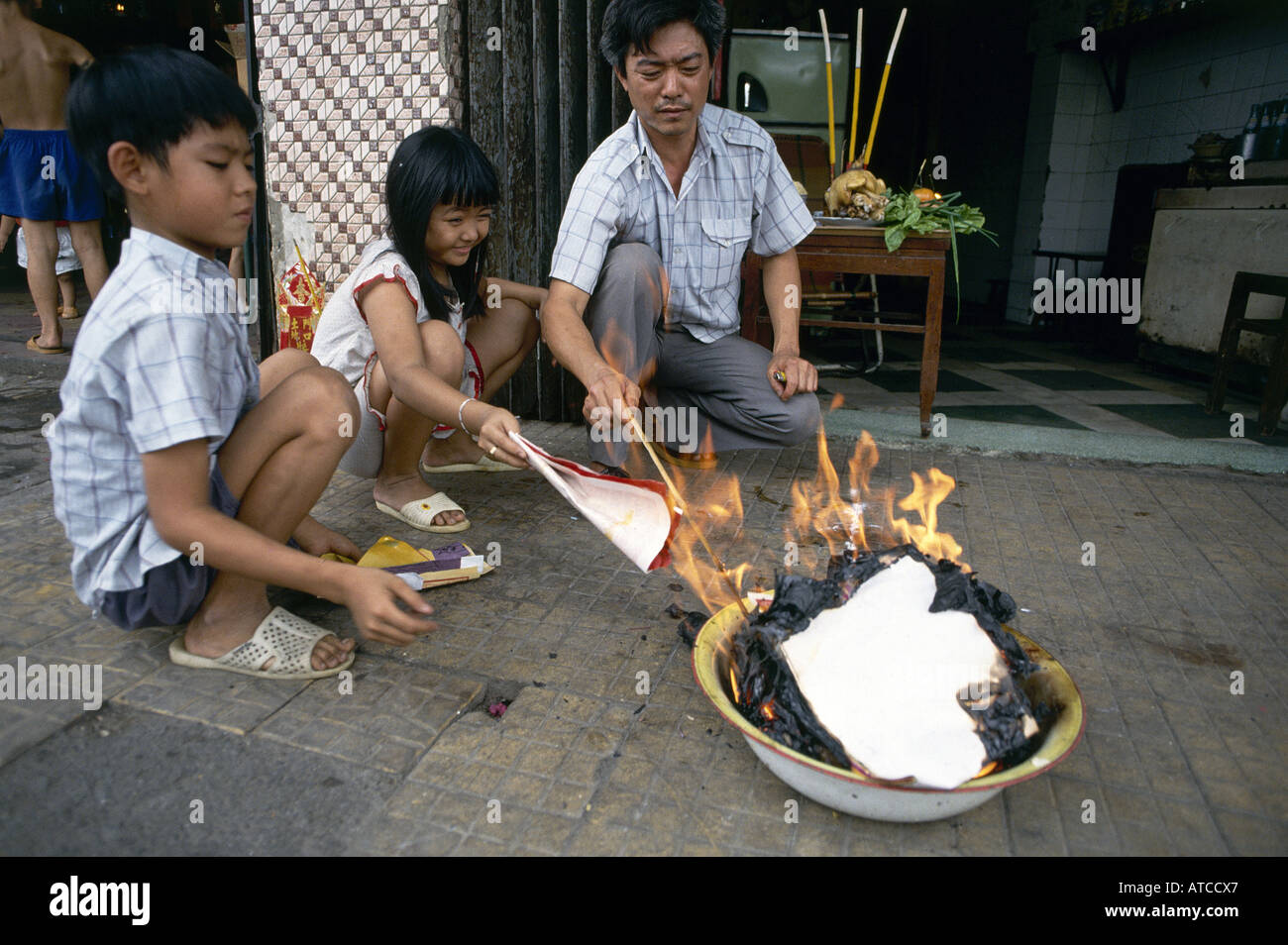 Burning paper offerings during the celebrations of the three day Tet festival the biggest event on the Vietnamese Calendar Stock Photo