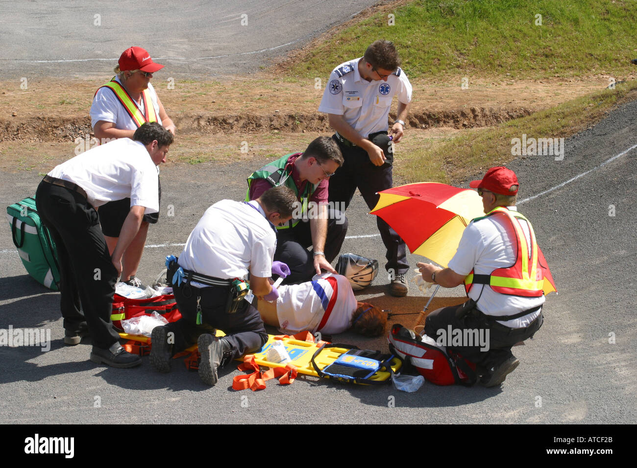 Medical assistance first aid team provide track side first aid to an