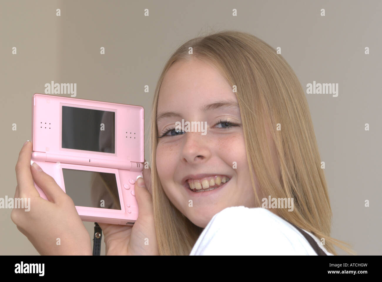 Young girl holding a Nintendo DS lite game console UK Stock Photo